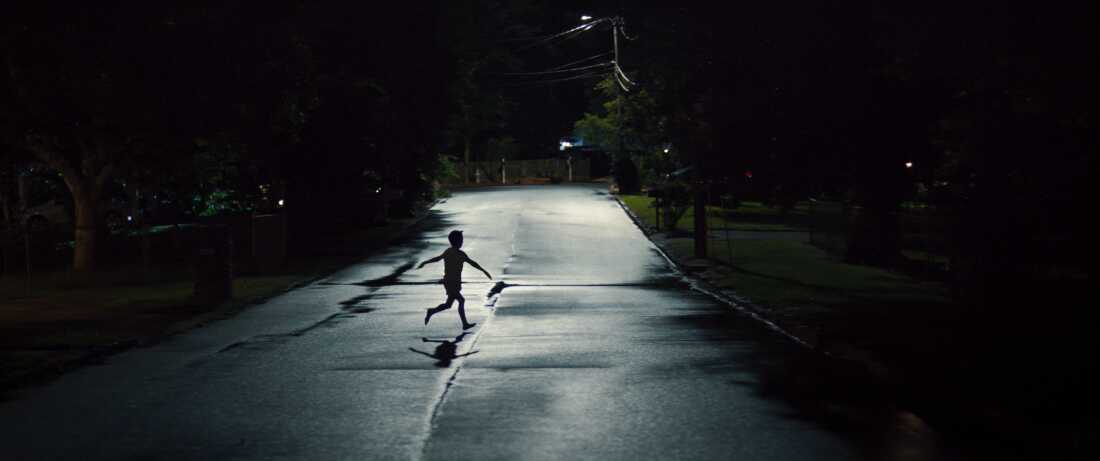 A child Naruto running into the night